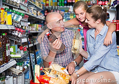 positive family choosing sunflower oil Stock Photo