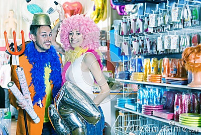 Positive family trying on helmet with horns Stock Photo