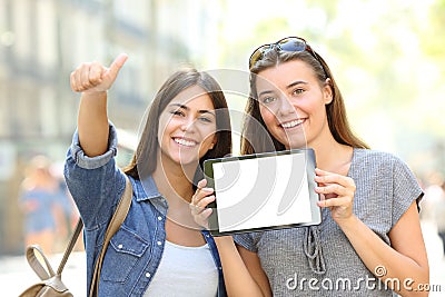 Positive friends showing a blank tablet screen Stock Photo