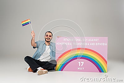 Positive gay man holding lgbt flag Stock Photo