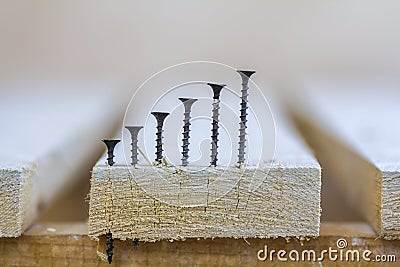 Positive graph made of screws as bar charts on board background Stock Photo