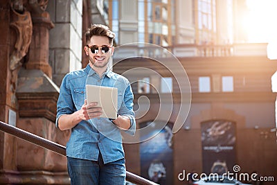 Positive guy using tablet Stock Photo