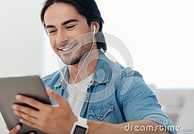 Positive handsome man using tablet Stock Photo