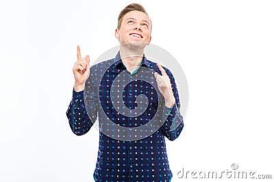 Positive handsome young male pointing up with both hands Stock Photo
