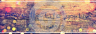 Positive inspiring quote written carved in wood Love the life you live. Best motivational quotes, inspirational quotes and sayings Stock Photo