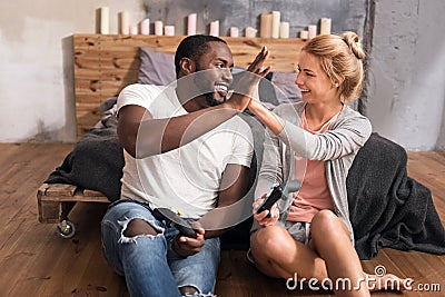 Positive international couple relaxing at home Stock Photo