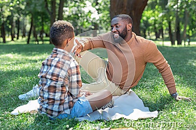 Positive joyful man speaking with his son Stock Photo