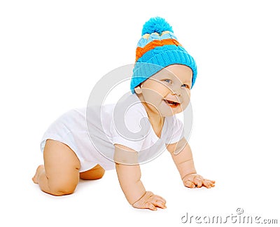 Positive little baby crawls in the knitted hat Stock Photo