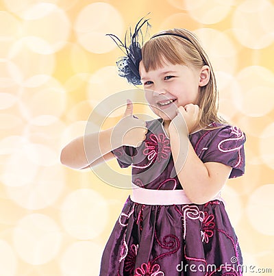 Positive little girl showing thumb up. Stock Photo