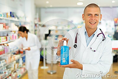 Male pharmacist offers various body care medicines Stock Photo