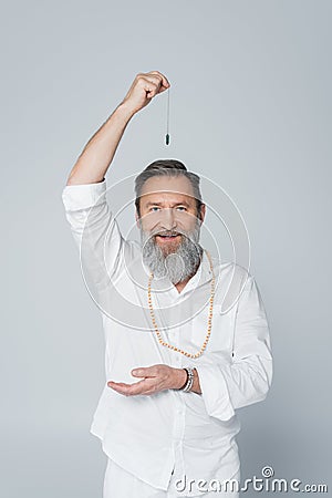 positive master guru with dowsing pendulum Stock Photo