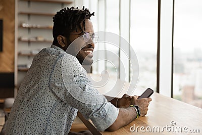 Stylish young black guy enjoy weekend at home with smartphone Stock Photo