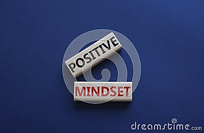 Positive Mindset symbol. Concept words Positive Mindset on wooden blocks. Beautiful deep blue background. Business and Positive Stock Photo