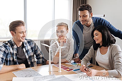 Positive nice team of engineers trying to save the energy Stock Photo