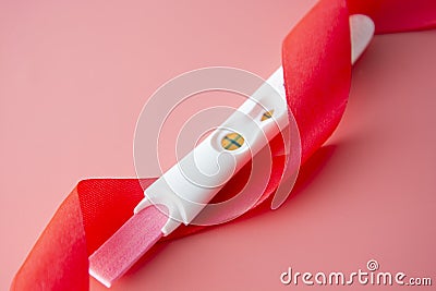 Positive platic pregnancy test isolated on pink background Stock Photo