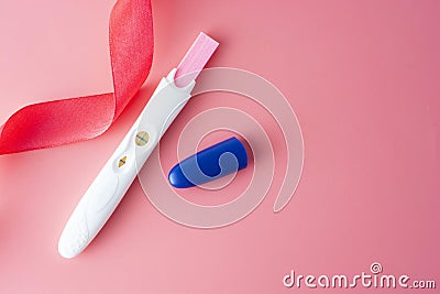 Positive platic pregnancy test isolated on pink background, copy space Stock Photo