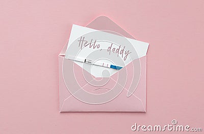 Positive pregnancy test in pink envelope on pink background, postcard with inscription hello, daddy, pregnancy concept Stock Photo