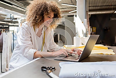 positive saleswoman with measuring tape using Stock Photo
