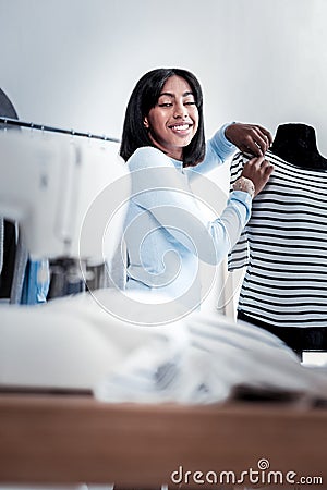 Positive skillful woman looking at the table Stock Photo