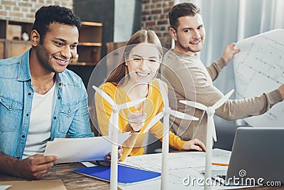 Positive three colleagues working with models Stock Photo