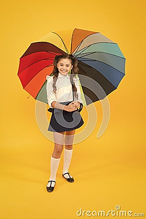 Positive vibes. Everything under control. Fancy schoolgirl. Girl with umbrella. Rainy day. Happy childhood. Rainbow Stock Photo