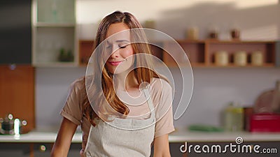 Positive woman dancing on modern kitchen. Housewife cooking dinner on kitchen Stock Photo