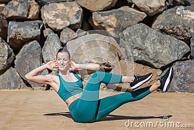 Positive woman doing abs twist Stock Photo