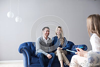 Positive young couple consulting a psychologist Stock Photo