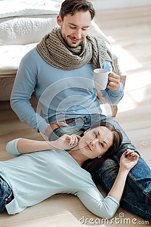 Positive young couple enjoying the weekend at home Stock Photo