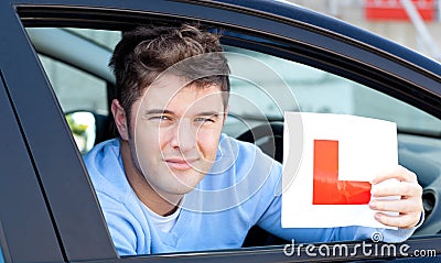 Positive young male driver holding a L sign Stock Photo