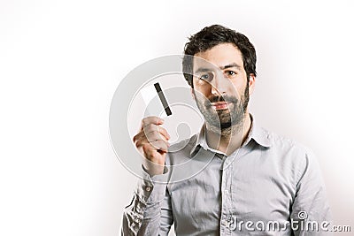 Positive young man holding a credit card Stock Photo