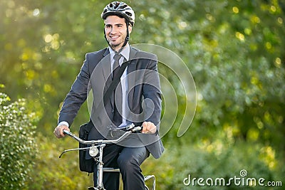 Positive young man riding a bicycle to work Stock Photo