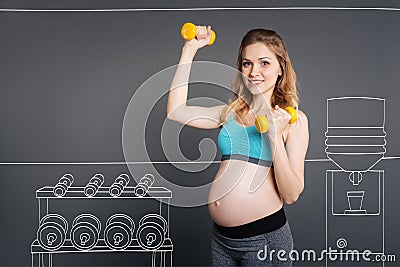 Positive young pregnant woman enjoying sport exercises. Stock Photo