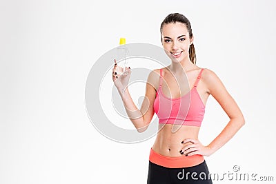 Positive young sportswoman holding a bottle of water Stock Photo