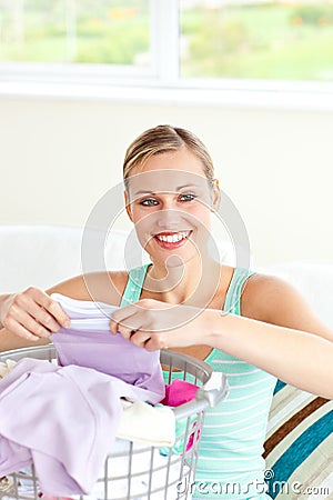 Positive young woman doing the laundry Stock Photo