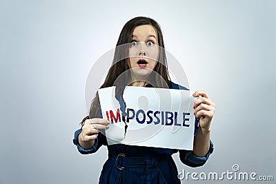 Positivity concept, woman tearing word impossible to make possible Stock Photo