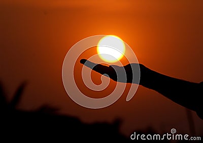 Is it possible to hold the sun above your hand but it is possible to capture the sun just like in the picture Stock Photo