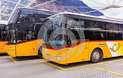 Post Buses at the bus station in the city of Chur in Switzerland Editorial Stock Photo