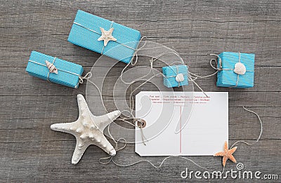 Post card with a starfish and turquoise gifts and a wooden backgr Stock Photo