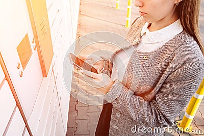 Post locker. Delivery automat terminal and hands with parcel courier box. Parcel delivery, pickup point with lockers Stock Photo