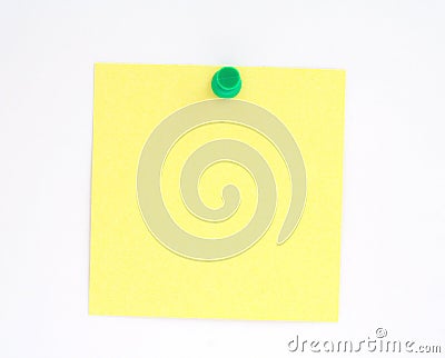 Yellow note pinned to white paper wall Stock Photo