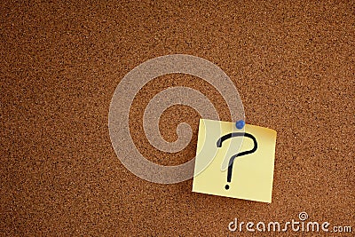 Post it note with question mark on bulletin board Stock Photo