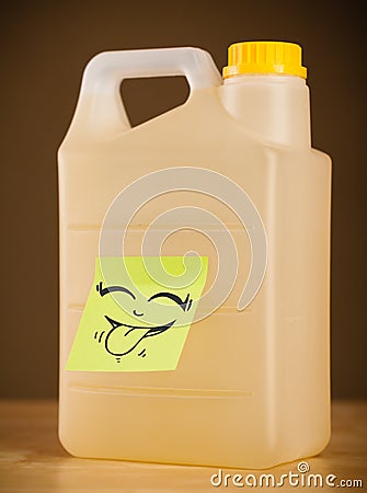 Post-it note with smiley face sticked on gallon Stock Photo