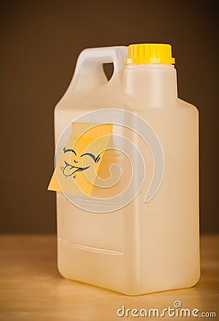Post-it note with smiley face sticked on gallon Stock Photo