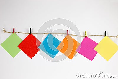 Post-it notes with small colored pegs Stock Photo