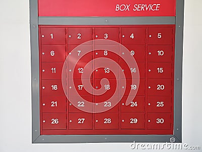 Post office mailbox box service screen white text number one to thirty on front red steel with key Mortise lock, strack in the row Stock Photo