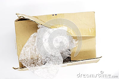Post parcel box with package plastic on white background, Unboxing process top view photo. Carton box opening. Stock Photo