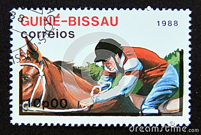 Postage stamp Guinea Bissau 1988. Equestrian jokey horse rider Editorial Stock Photo