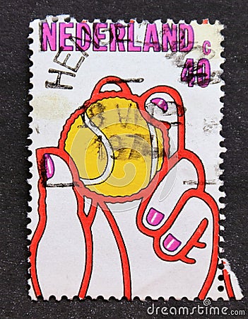 Post stamp printed in Netherlands tennis ball in hand Editorial Stock Photo