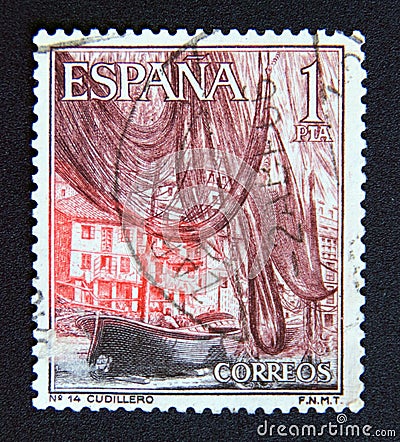 Postage stamp Spain 1965. Fishing nets and boat in the fishing port of Cudillero Asturias Editorial Stock Photo